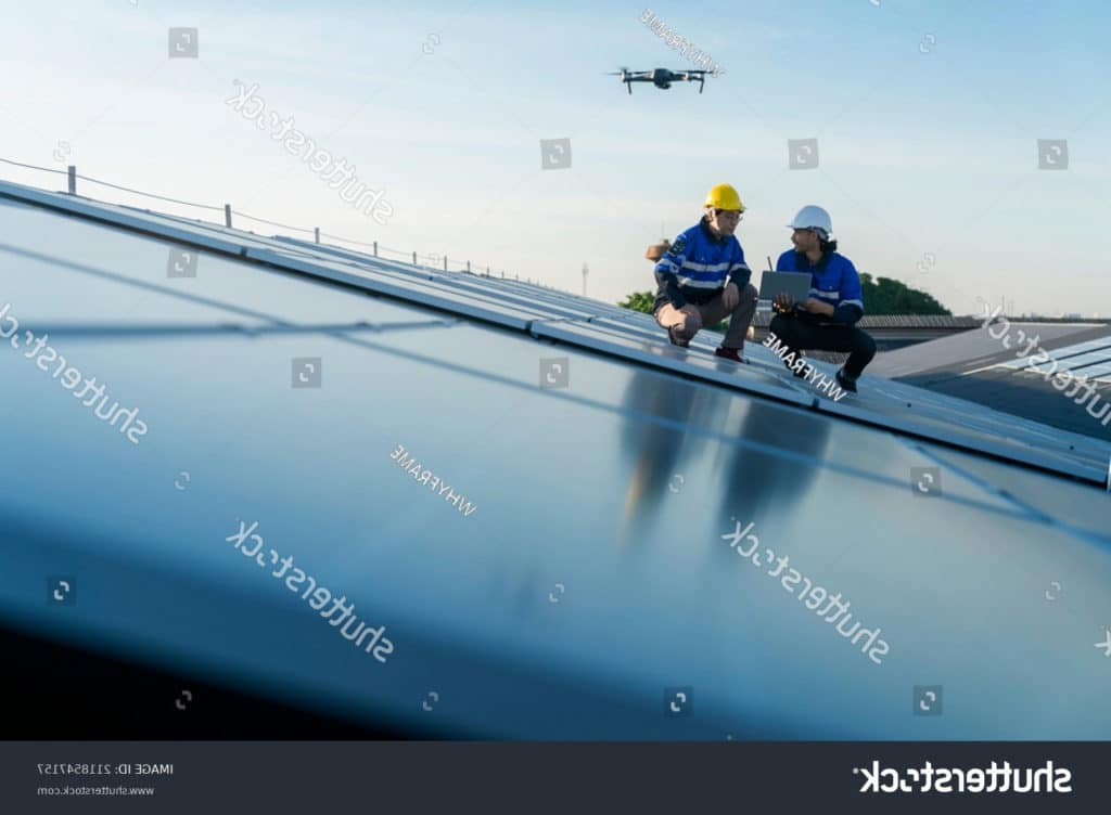 stock photo specialist technician professional engineercontrol drone checking top view of installing solar roof 2118547157